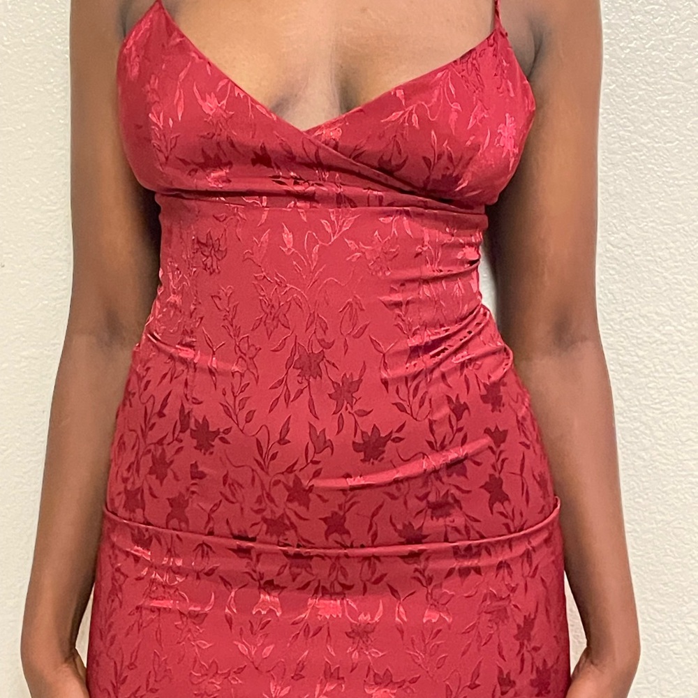 Red floral slip dress with adjustable straps and a split on the side.